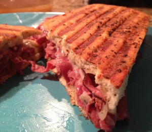 sliced roast beef, cheese, and seasonings stuffed on Focaccia bread and grilled on a panini press to create a French Dip Panini